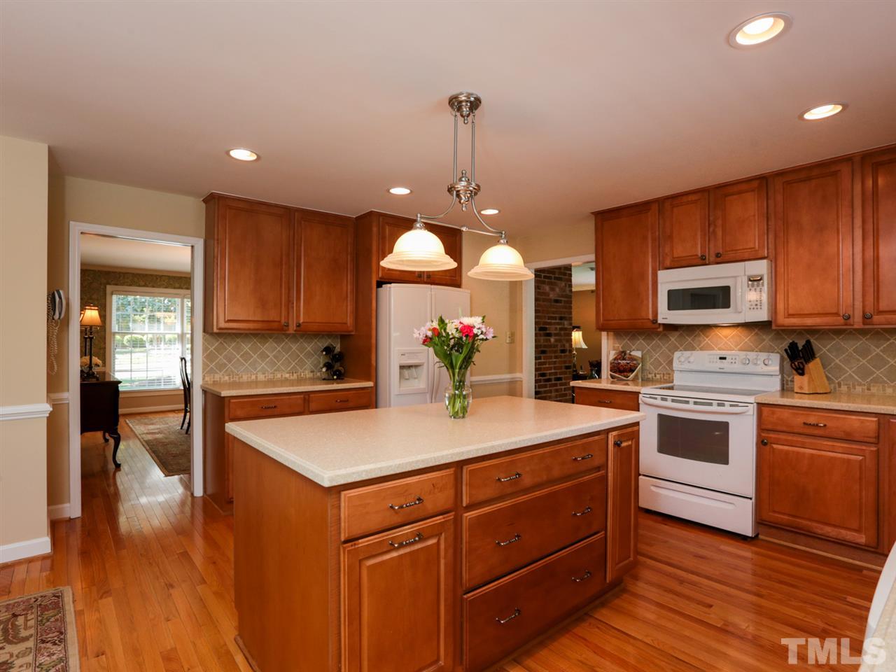 1413 Pony Run Road Raleigh, NC 27615 - Photo 7 of 25 a kitchen with a sink a stove and cabinets