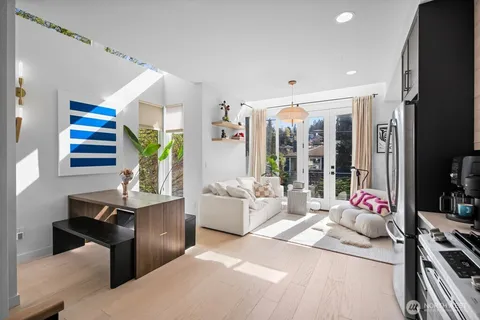 a bedroom with furniture and a large window