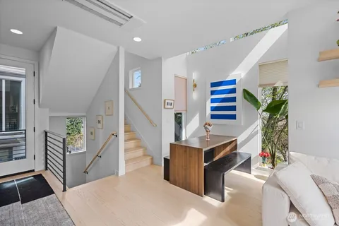 a living room with furniture and entryway