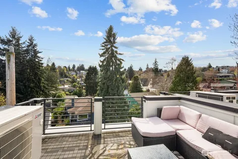 a view of a terrace with couches and sky view