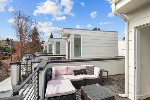 a balcony with furniture and a potted plant