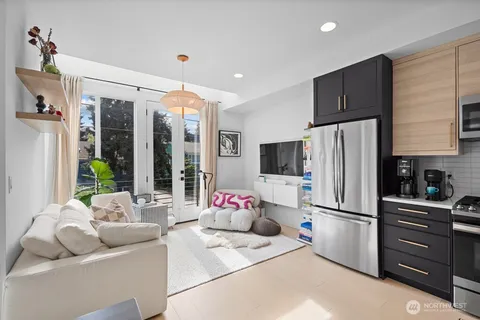 a kitchen with stainless steel appliances granite countertop a refrigerator a oven a sink and a refrigerator