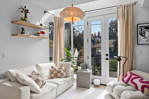a living room with furniture and a chandelier
