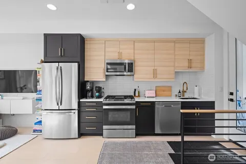a kitchen with a stove top oven and refrigerator