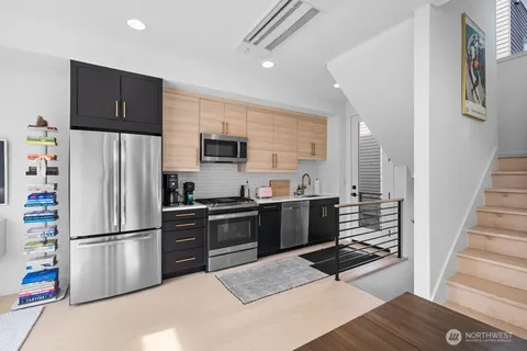 a kitchen with stainless steel appliances a refrigerator and a stove top oven