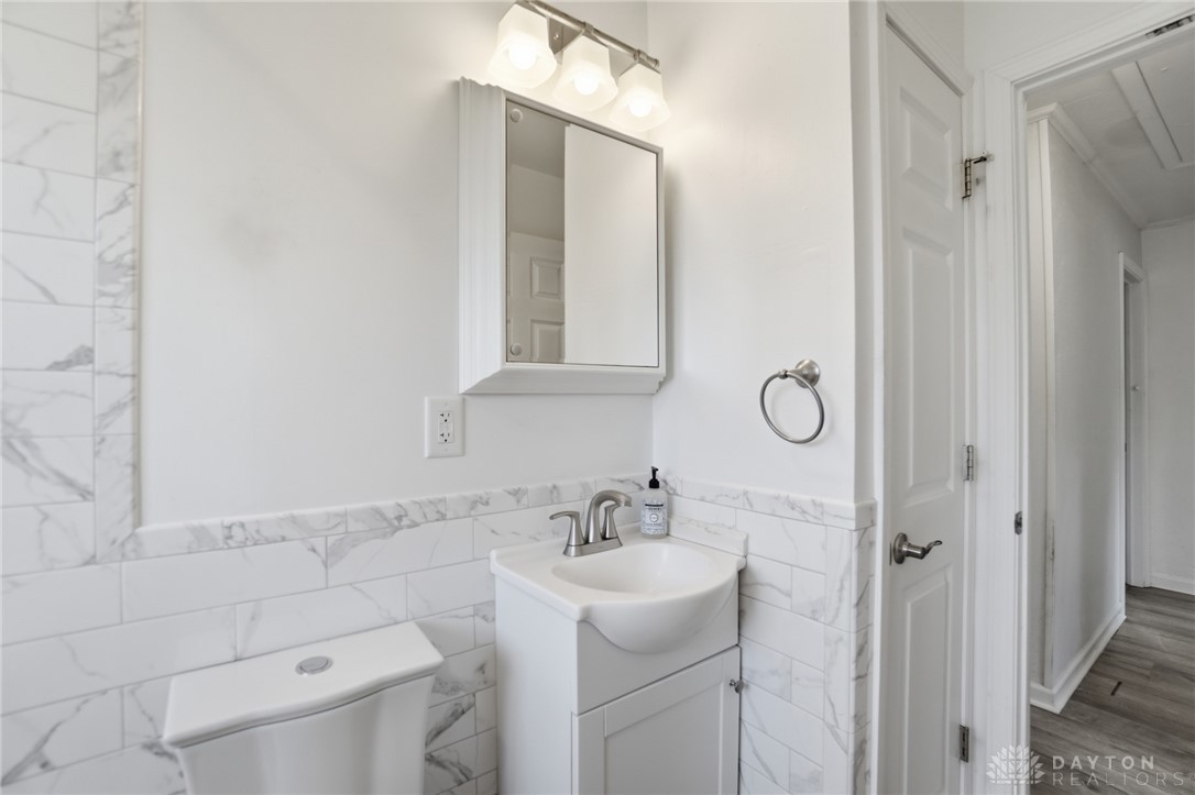 629 Storms Road Dayton, OH 45429 - Photo 38 of 51 This bright bathroom features sleek tile work and a functional vanity, perfect for daily routines.