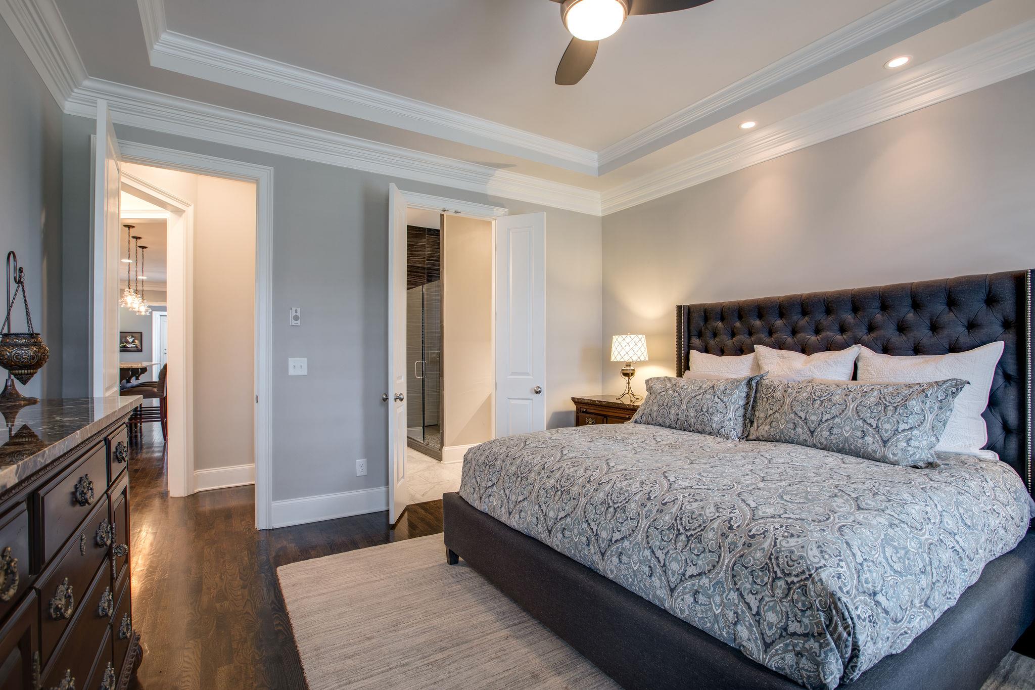 1367 Eliot Road Franklin, TN 37064 - Photo 17 of 30 a bedroom with a large bed and a chandelier