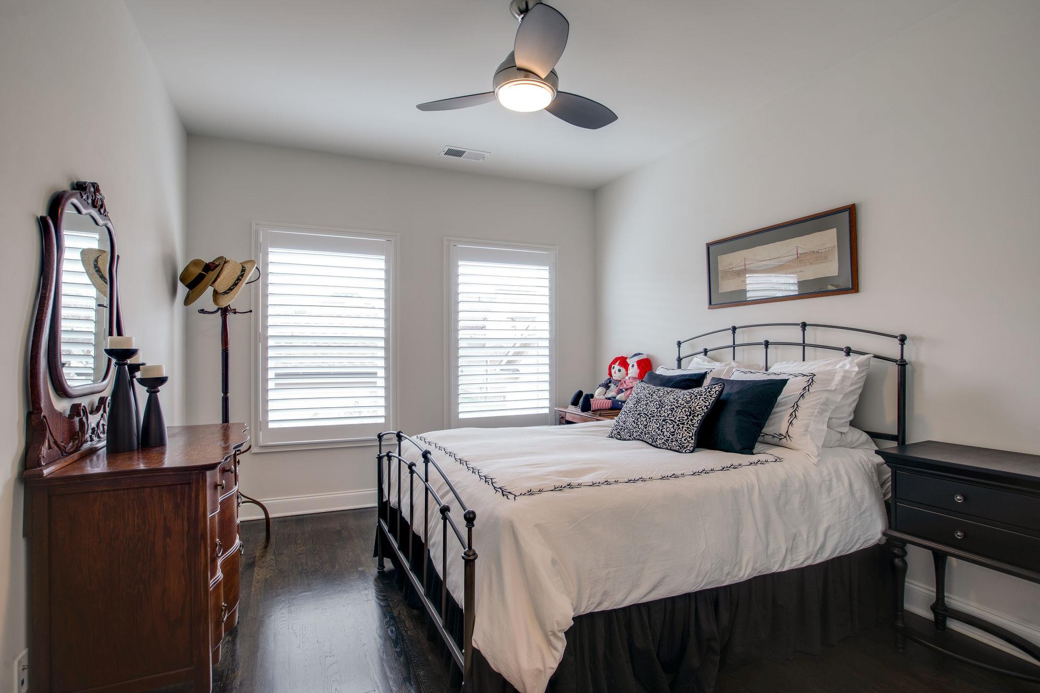 1367 Eliot Road Franklin, TN 37064 - Photo 27 of 30 a bedroom with a bed and a chandelier