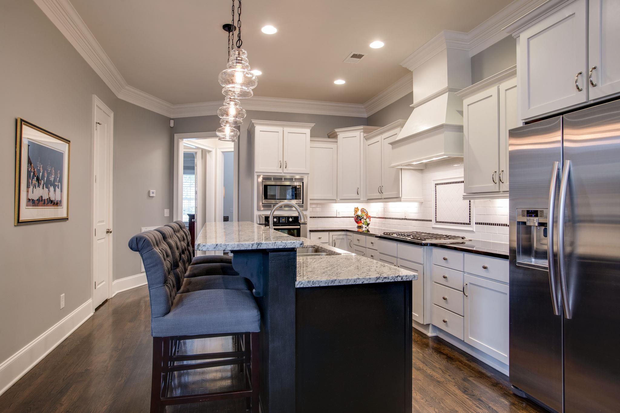 1367 Eliot Road Franklin, TN 37064 - Photo 6 of 30 a kitchen with granite countertop a center island a sink stainless steel appliances and cabinets