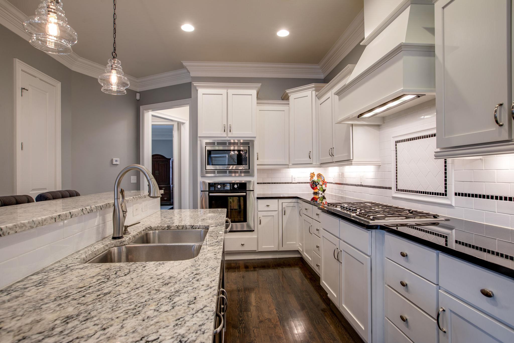 1367 Eliot Road Franklin, TN 37064 - Photo 7 of 30 a kitchen with stainless steel appliances granite countertop a sink stove and refrigerator