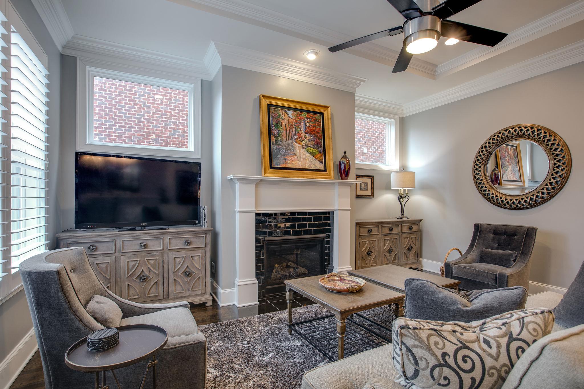 1367 Eliot Road Franklin, TN 37064 - Photo 10 of 30 a living room with furniture a flat screen tv and a fireplace