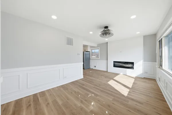 a view of a kitchen with wooden floor and a ceiling fan