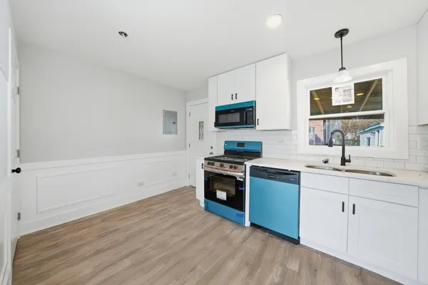 a kitchen with a sink appliances and cabinets