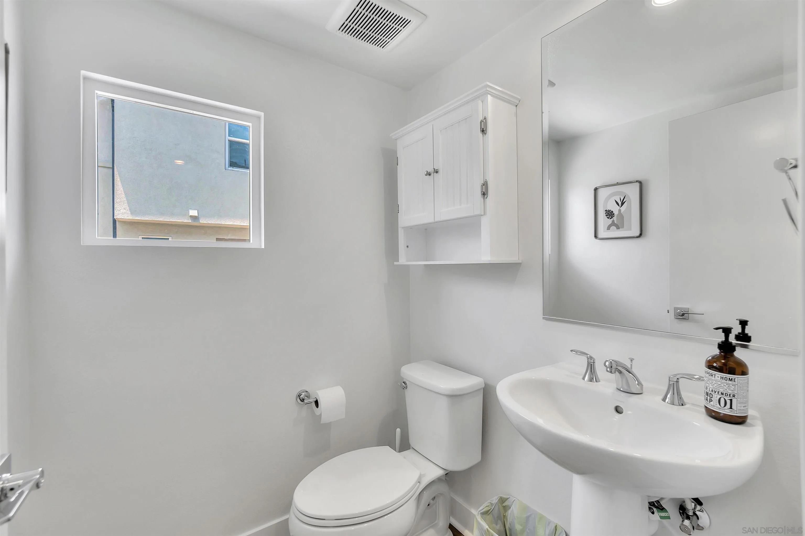 1531 West Bushell Street Anaheim, CA 92805 - Photo 12 of 27 a bathroom with a sink a mirror and a toilet