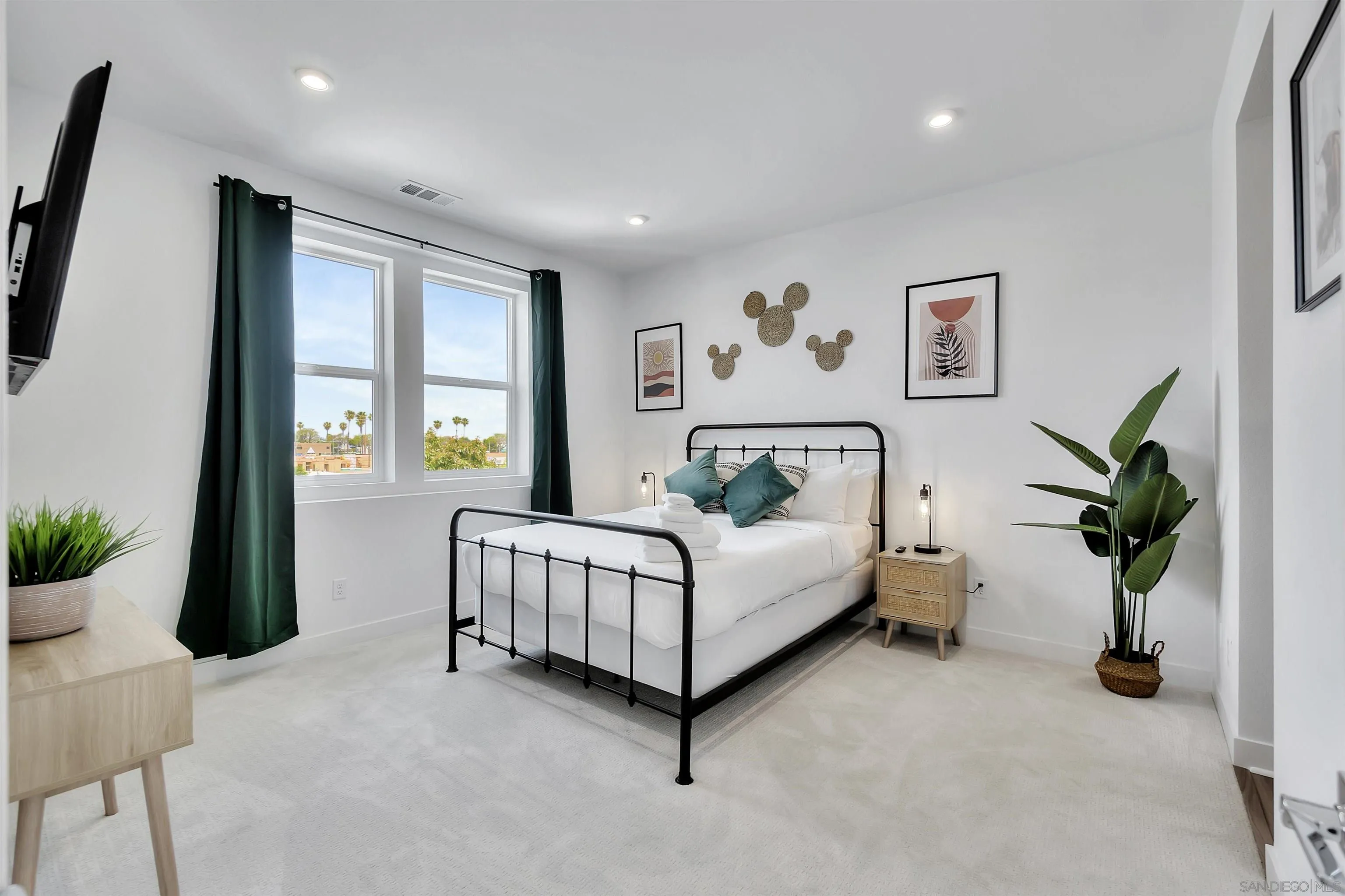 1531 West Bushell Street Anaheim, CA 92805 - Photo 18 of 27 a spacious bedroom with a large bed and a potted plant