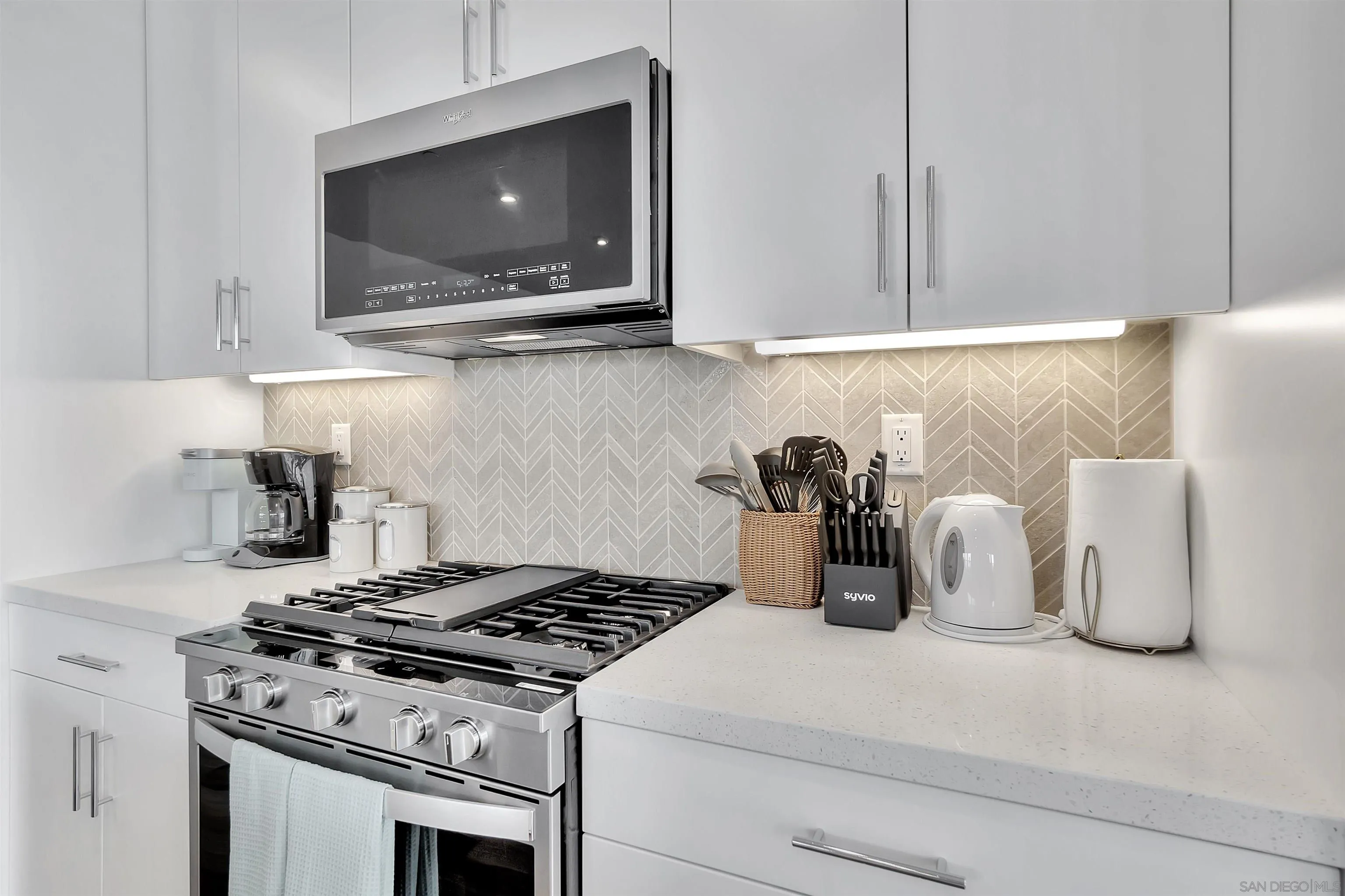 1531 West Bushell Street Anaheim, CA 92805 - Photo 9 of 27 a kitchen with a stove and a flat screen tv