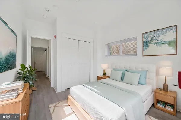 a bedroom with a bed and a potted plant