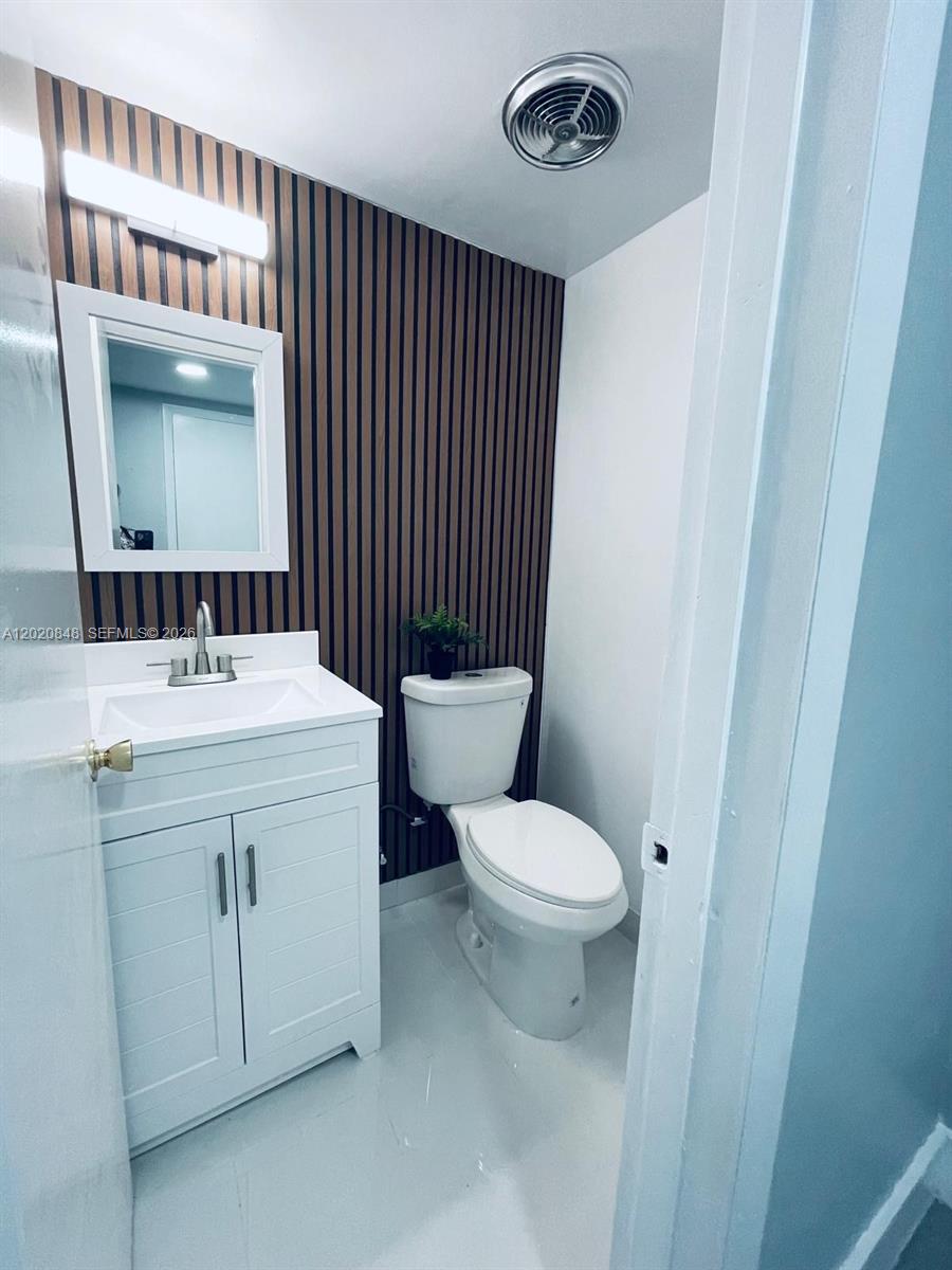 9175 Southwest 77th Avenue, Unit 306 Miami, FL 33156 - Photo 8 of 16 a bathroom with a sink a toilet a mirror and shower