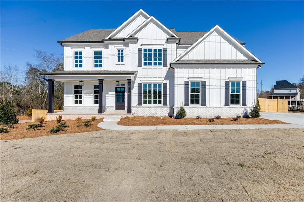 6115 Namon Wallace Road Cumming, GA 30028 - Photo 1 of 1 a front view of a house with a yard