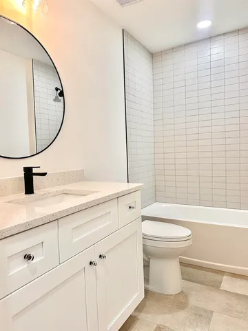 a bathroom with a sink a toilet and a mirror