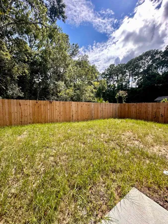 a view of yard with swimming pool and green space