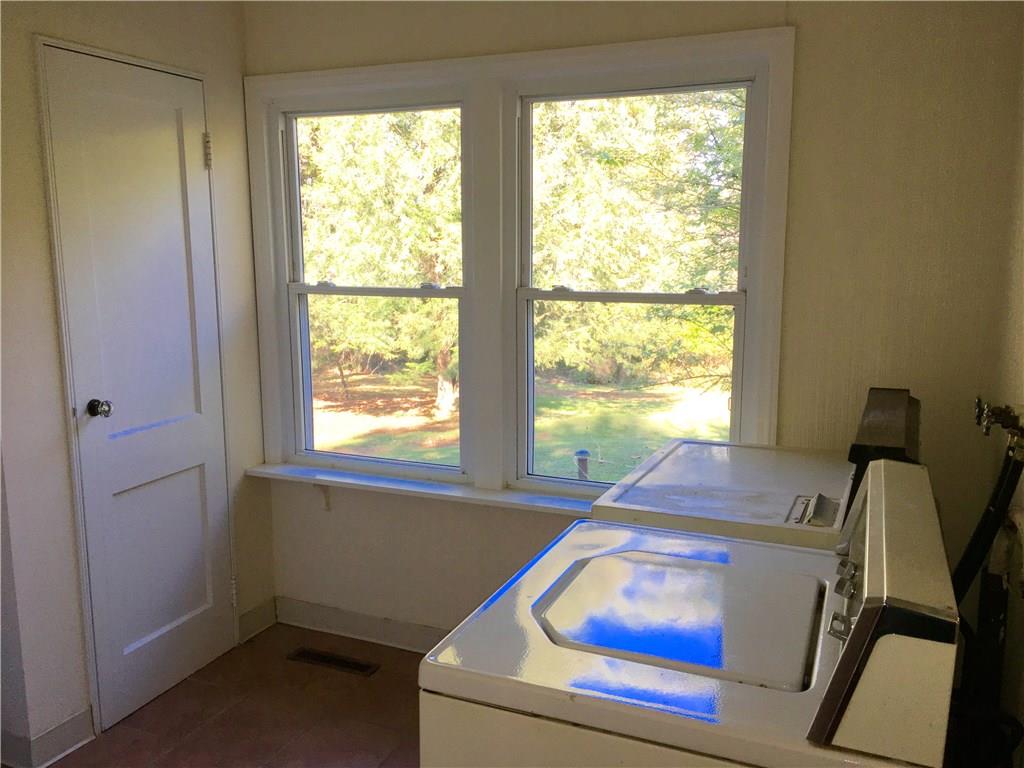 117 Azalea Lane Rector, PA 15677 - Photo 18 of 25 The first floor Laundry Room affords nice views to the back yard. There are actually two closets in this room. One has a doggy door leading to the covered porch/deck and fenced yard.