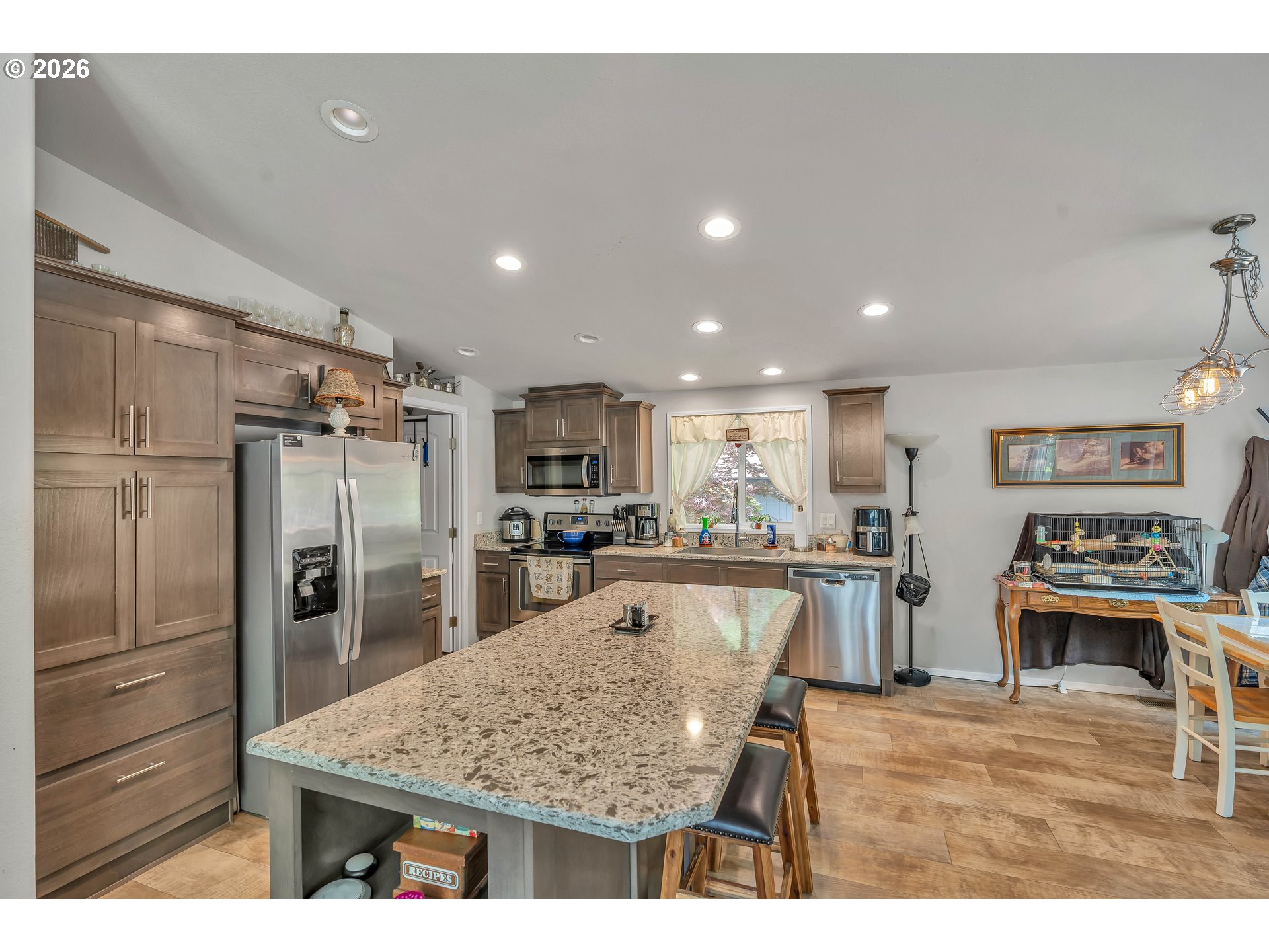 21494 Hideway Lane Rhododendron, OR 97049 - Photo 11 of 34 a kitchen with stainless steel appliances granite countertop a refrigerator oven a sink dishwasher and white cabinets with wooden floor