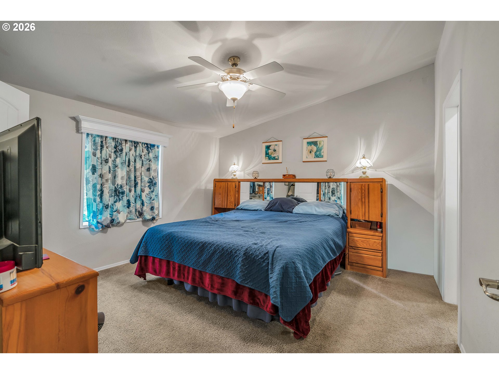 21494 Hideway Lane Rhododendron, OR 97049 - Photo 20 of 34 a bedroom with a large bed and a flat tv screen on dresser