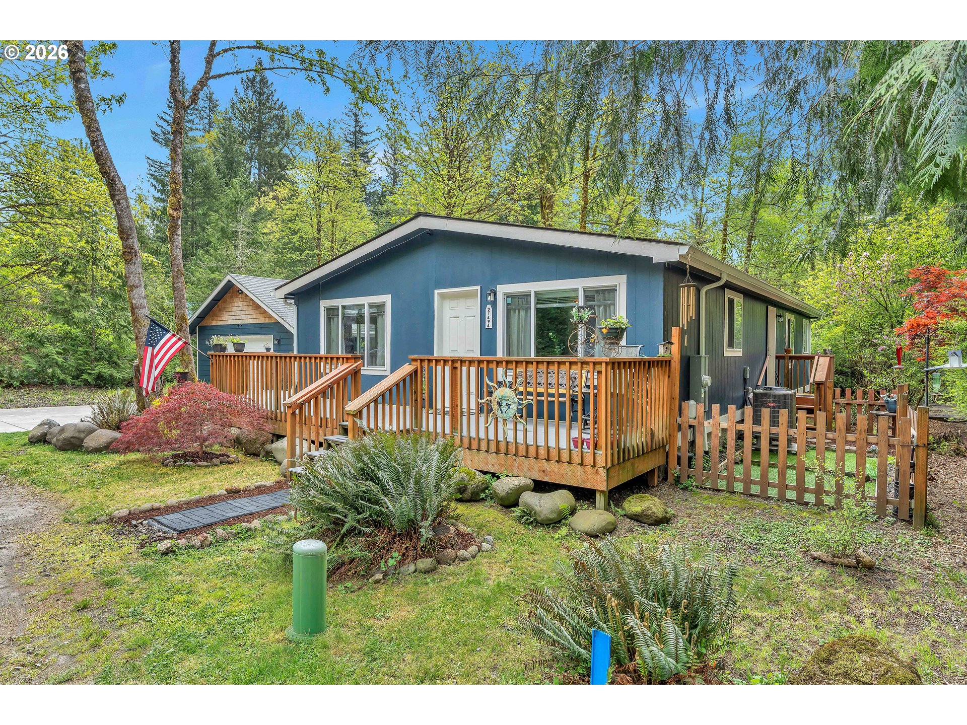 21494 Hideway Lane Rhododendron, OR 97049 - Photo 2 of 34 a view of a house with a yard and deck