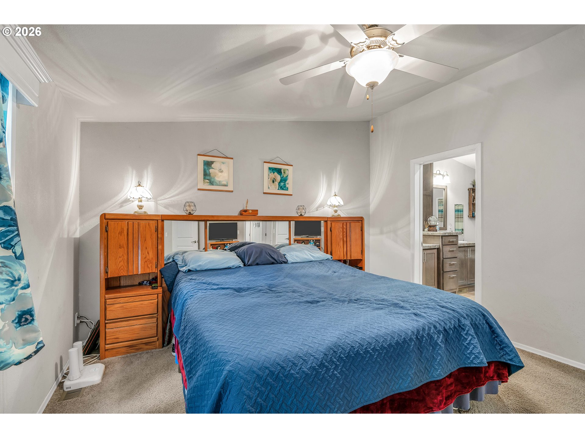 21494 Hideway Lane Rhododendron, OR 97049 - Photo 21 of 34 a bedroom with a bed and a chandelier