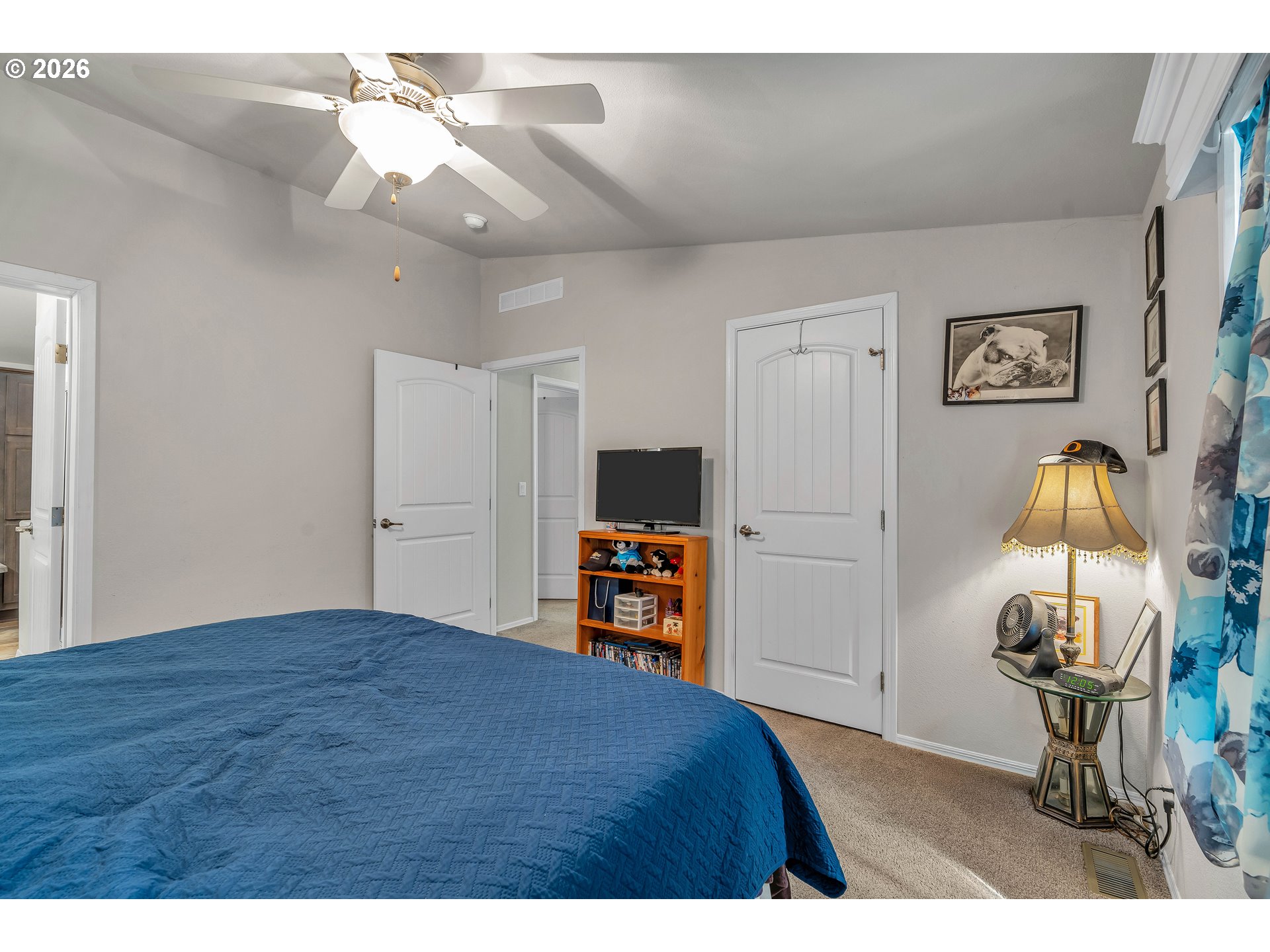 21494 Hideway Lane Rhododendron, OR 97049 - Photo 22 of 34 a bedroom with a bed and a chandelier