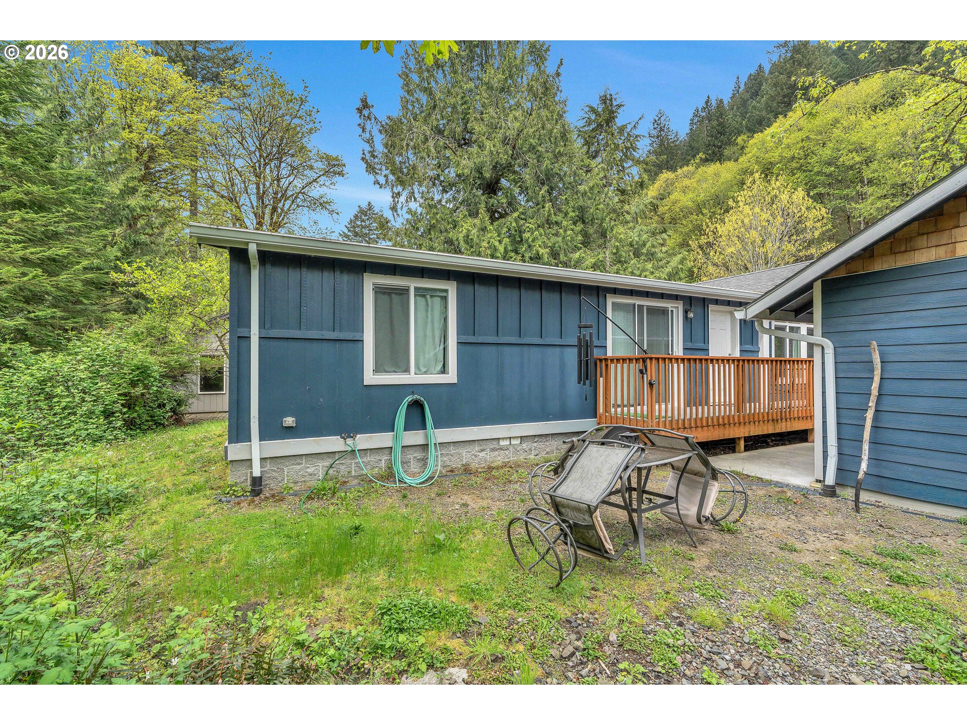 21494 Hideway Lane Rhododendron, OR 97049 - Photo 32 of 34 a backyard of a house with table and chairs