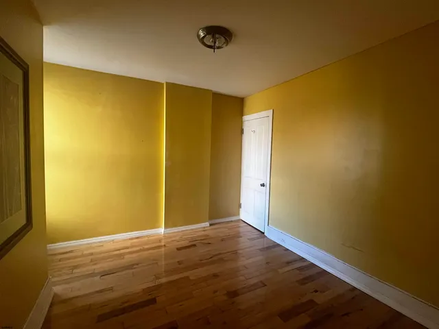 a view of a room with wooden floor