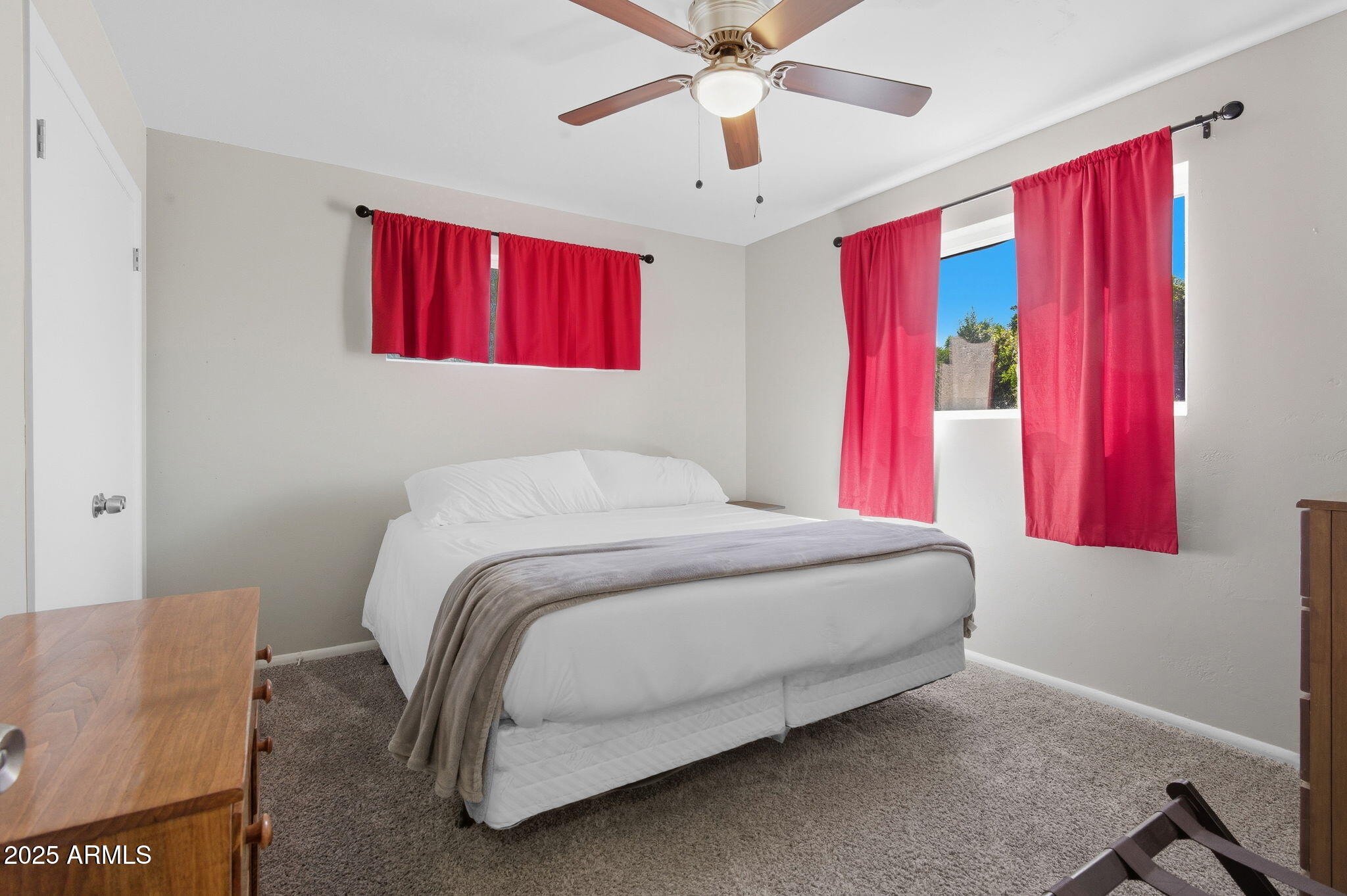 1802 East Meadowbrook Avenue Phoenix, AZ 85016 - Photo 15 of 28 a bedroom with a bed and a chandelier