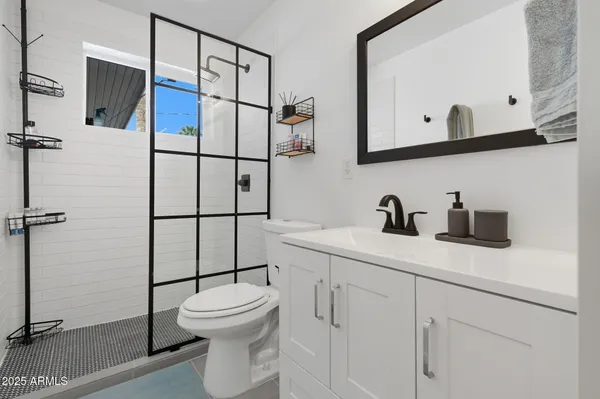 a bathroom with a toilet sink and mirror