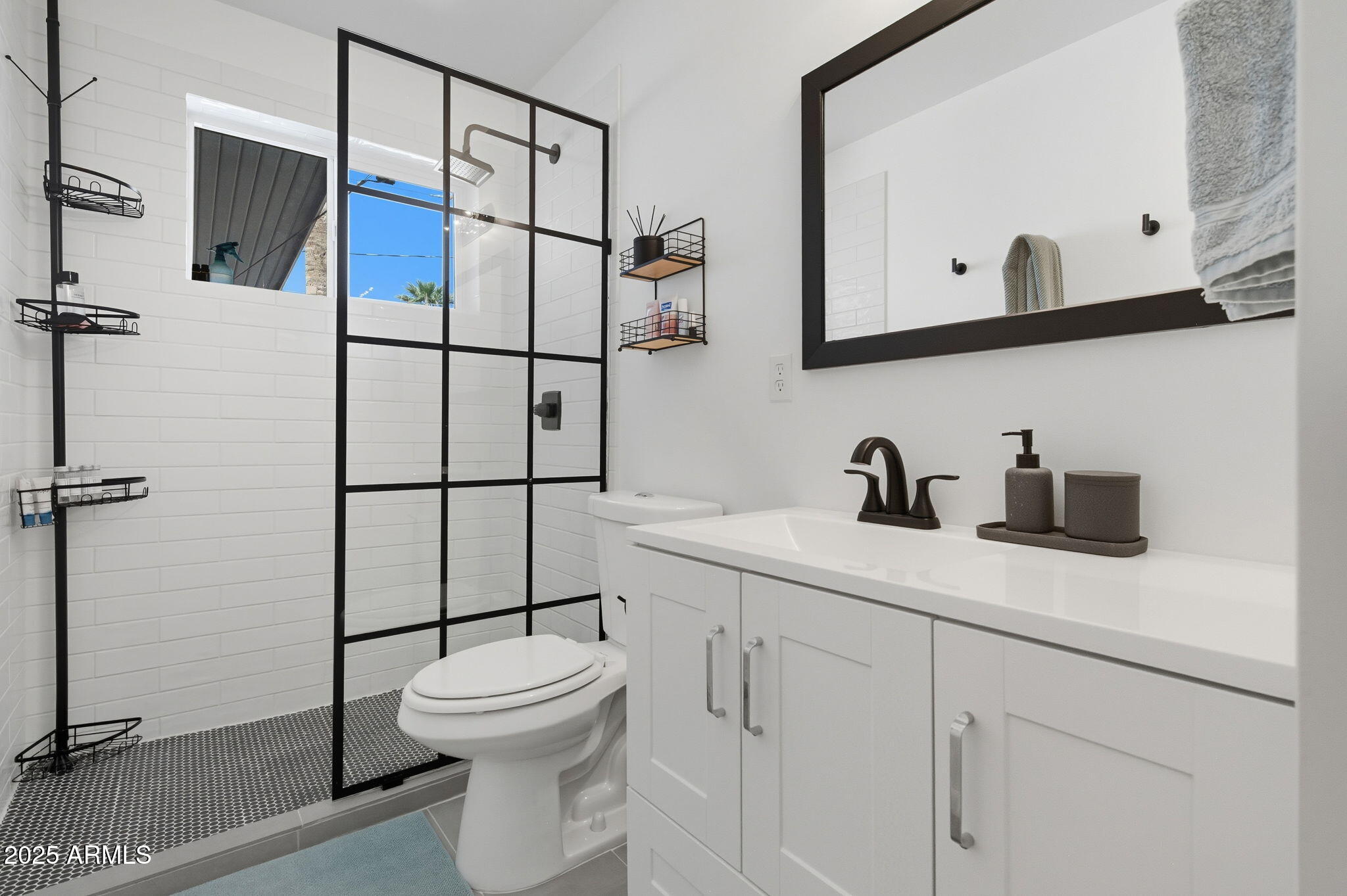 1802 East Meadowbrook Avenue Phoenix, AZ 85016 - Photo 17 of 28 a bathroom with a toilet sink and mirror