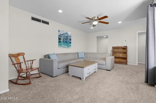 a living room with furniture and a dining table