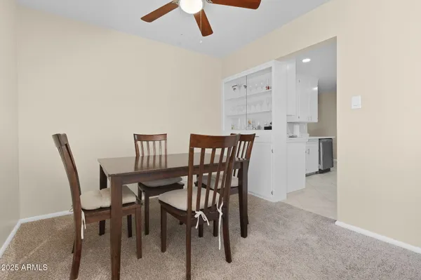 a living room with furniture and a ceiling fan