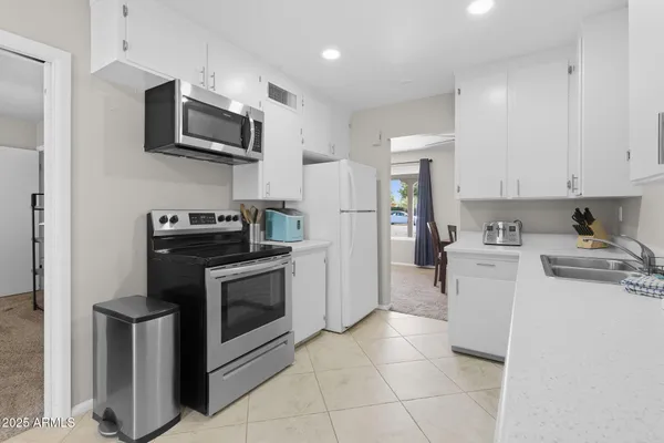 a kitchen with cabinets and window