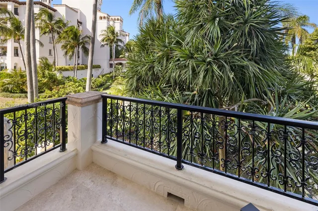 a room with furniture a large window and wooden floors