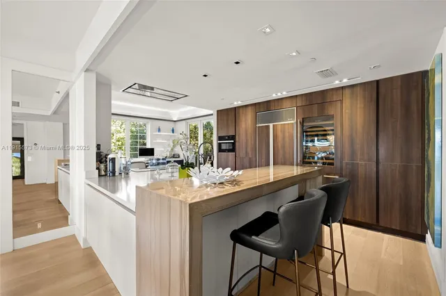 a kitchen with stainless steel appliances granite countertop a refrigerator and a sink