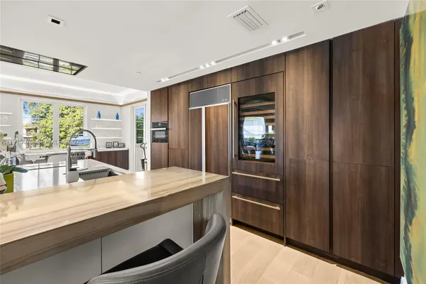 a spacious bedroom with a bed a table and chair