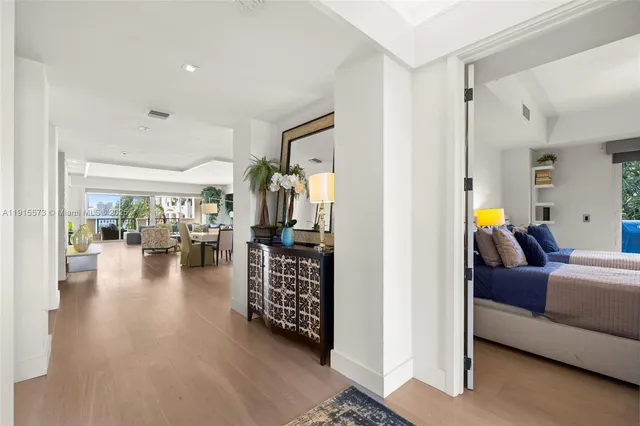 a spacious bedroom with a bed a table and chair