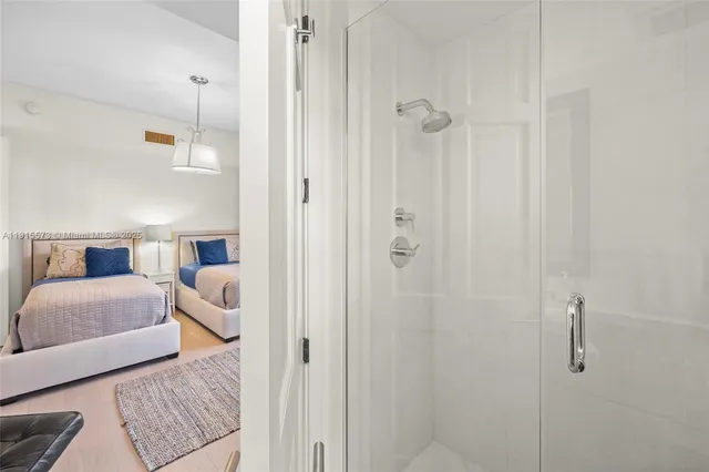 a large bedroom with a large bed and wooden floor