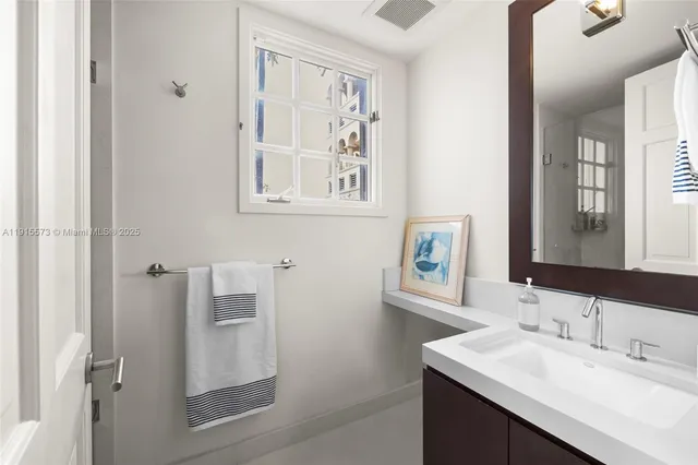 a bedroom with furniture and a large window