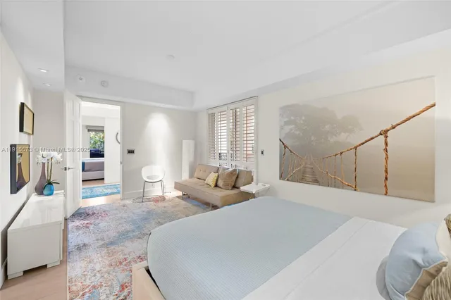 a spacious bedroom with a bed and a couch