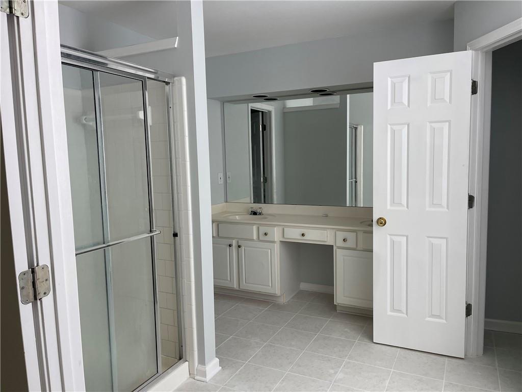 3118 Stanstead Court Norcross, GA 30071 - Photo 12 of 14 a bathroom with a sink and mirror