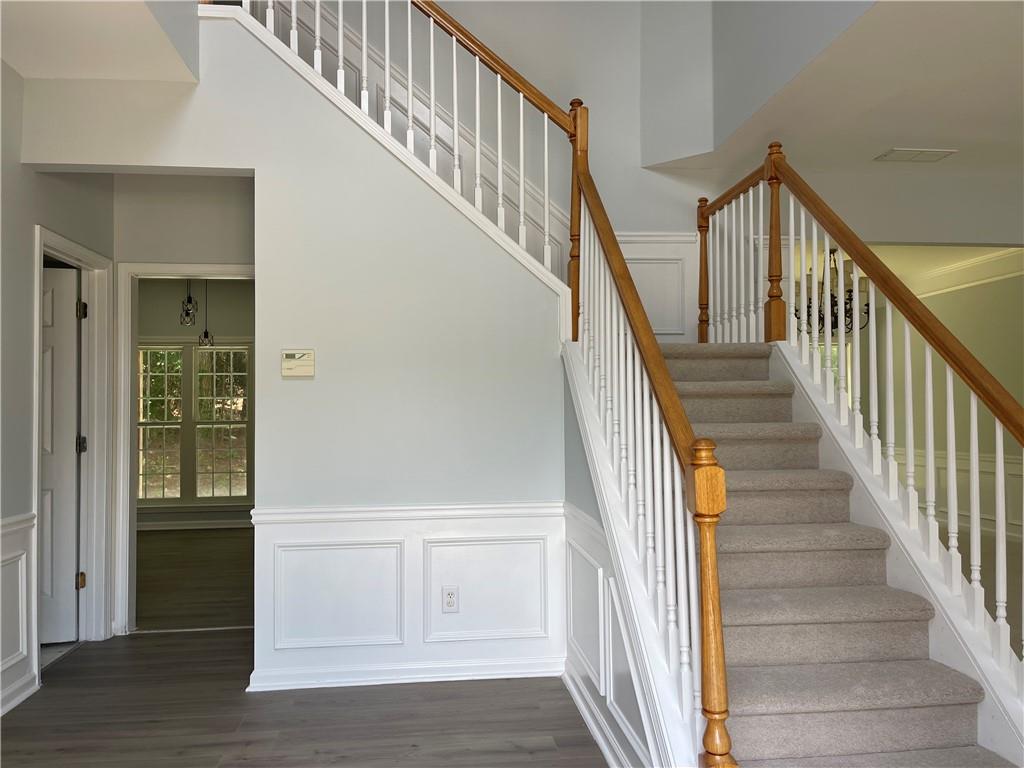 3118 Stanstead Court Norcross, GA 30071 - Photo 3 of 14 a view of staircase with wooden floor and white walls