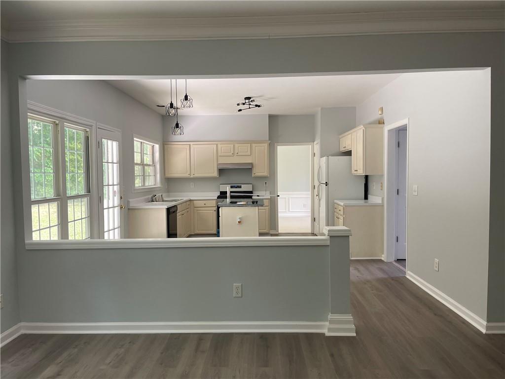 3118 Stanstead Court Norcross, GA 30071 - Photo 7 of 14 a view of a kitchen with stainless steel appliances wooden floor and large windows