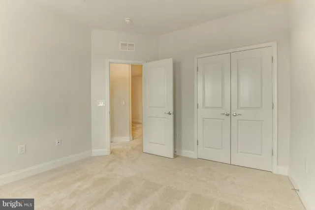 an empty room with closet area